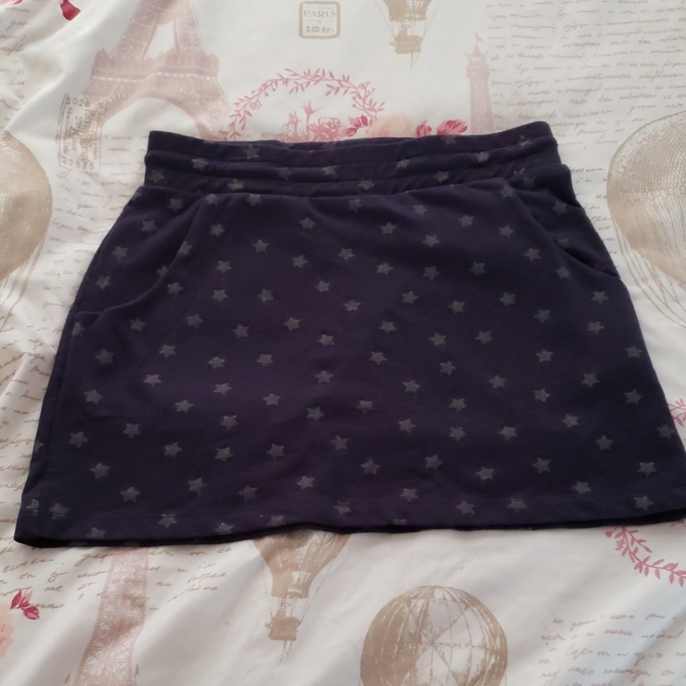 A blue skirt with silver stars and pockets
